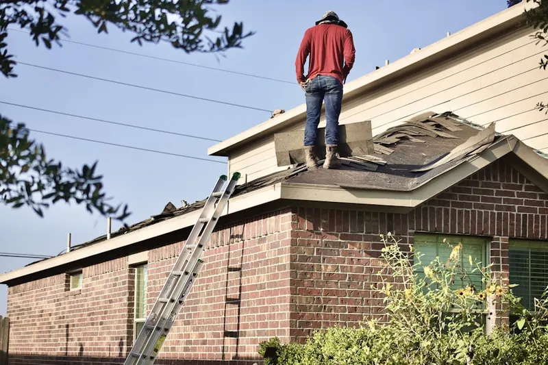 Professional roofer working on a residential roof in Pointe Bleue